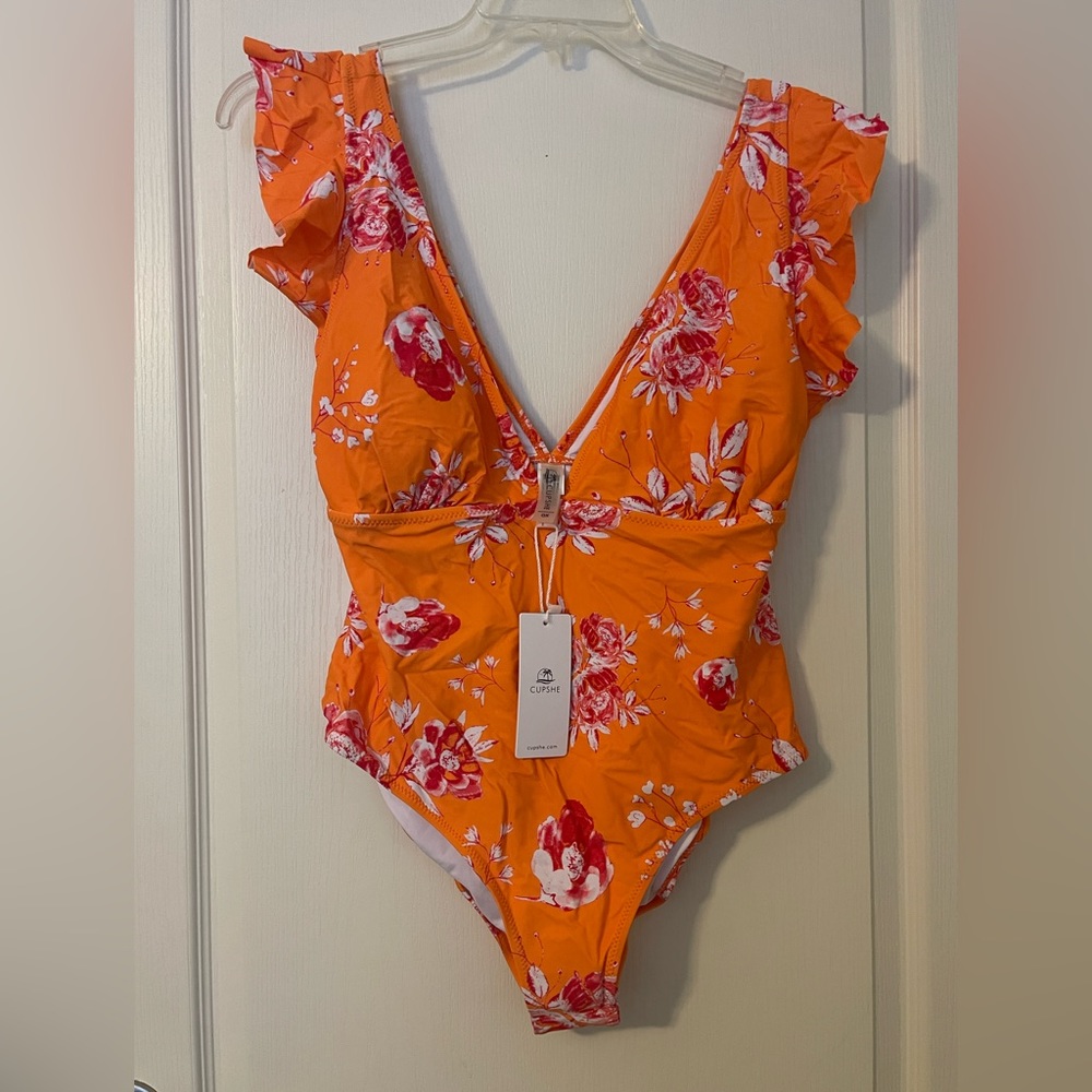 One piece plunge neck ruffled one piece swimsuit. Bright colors!